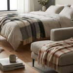 Chambre et salon aménagés avec des plaids confortables sur un lit en lin et un canapé modulable, pour une ambiance cosy.