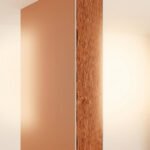 Coupe transversale d'un mur montrant une couche d'isolant minéral entre deux plaques de plâtre.